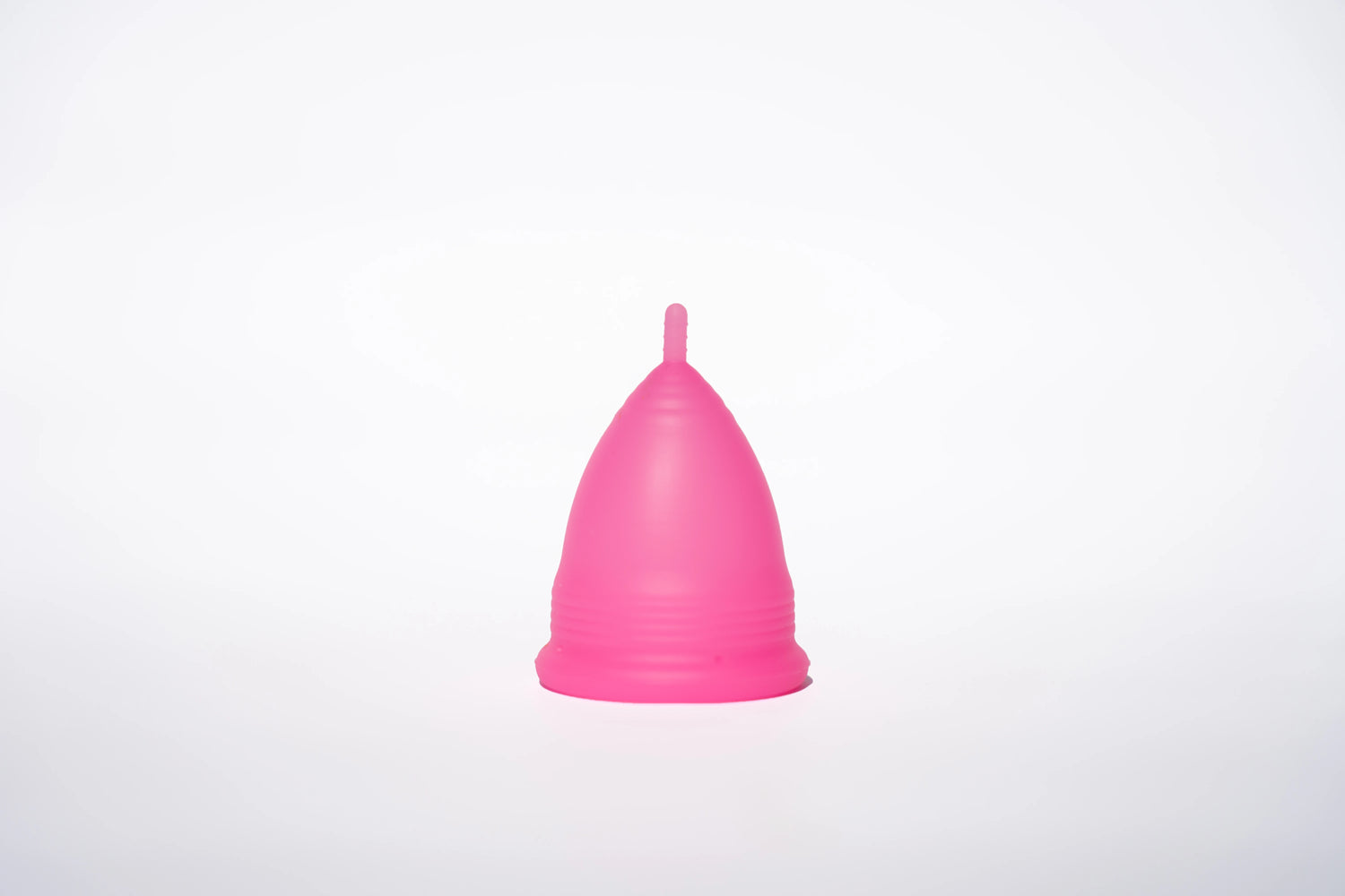 POM Super Soft Menstrual Cup in hot pink, made from 100% medical-grade silicone, featuring ribbed edges and a shorter stem for added comfort.