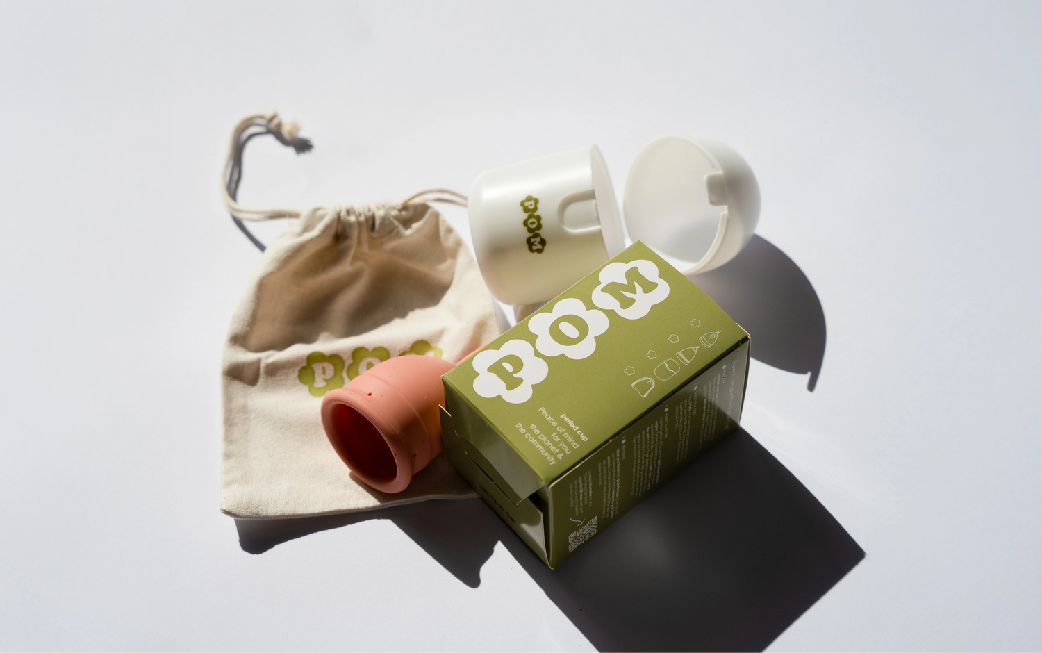 POM Finger Grip Menstrual Cup Pack, including a light peach 100% medical-grade silicone cup, branded box, organic cotton travel bag, and steriliser case.