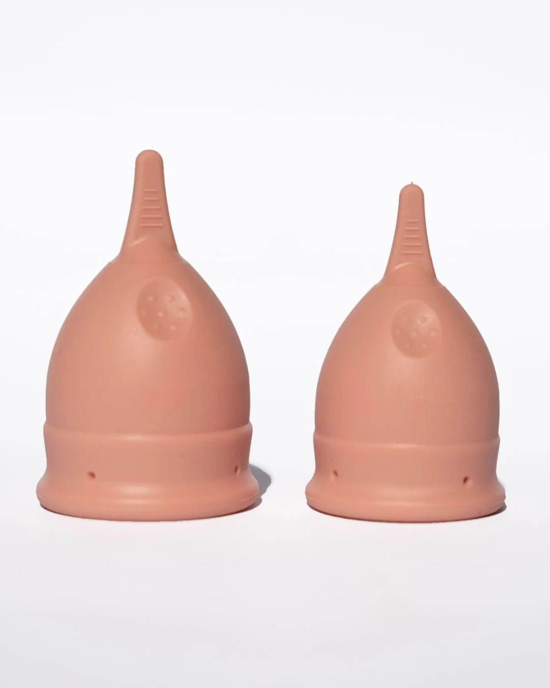 POM Finger Grip Menstrual Cup in light peach. Made from 100% medical-grade silicone, this soft, flexible cup features an easy-to-hold finger grip design for comfortable insertion and removal.