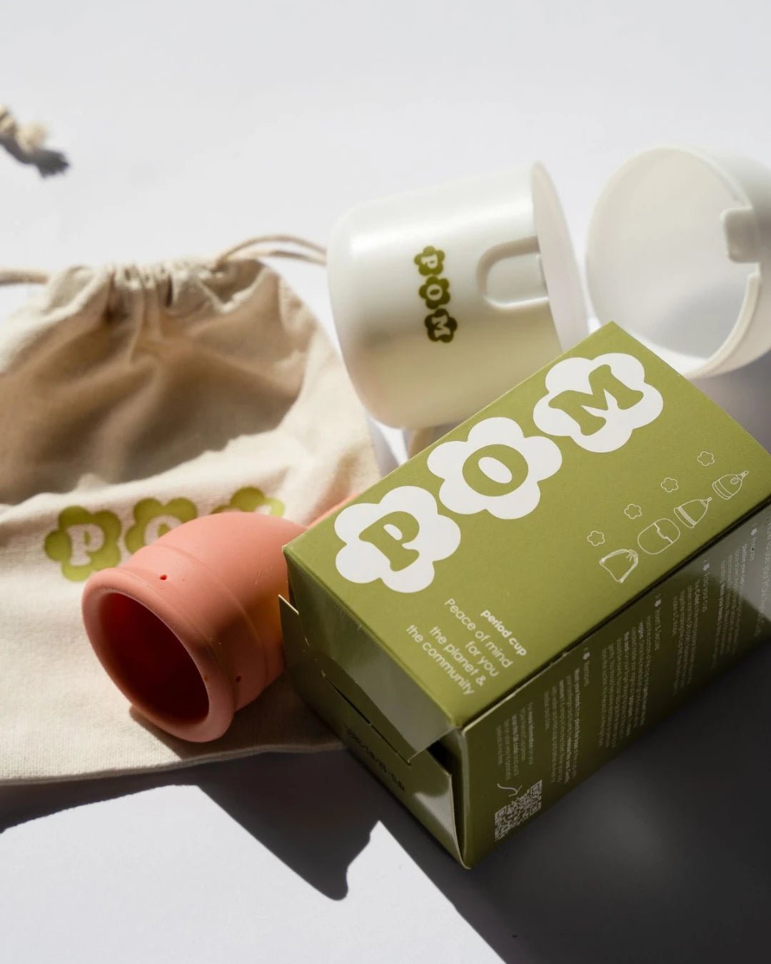 POM Finger Grip Menstrual Cup in light peach. Made from 100% medical-grade silicone, this soft, flexible cup features an easy-to-hold finger grip design for comfortable insertion and removal.