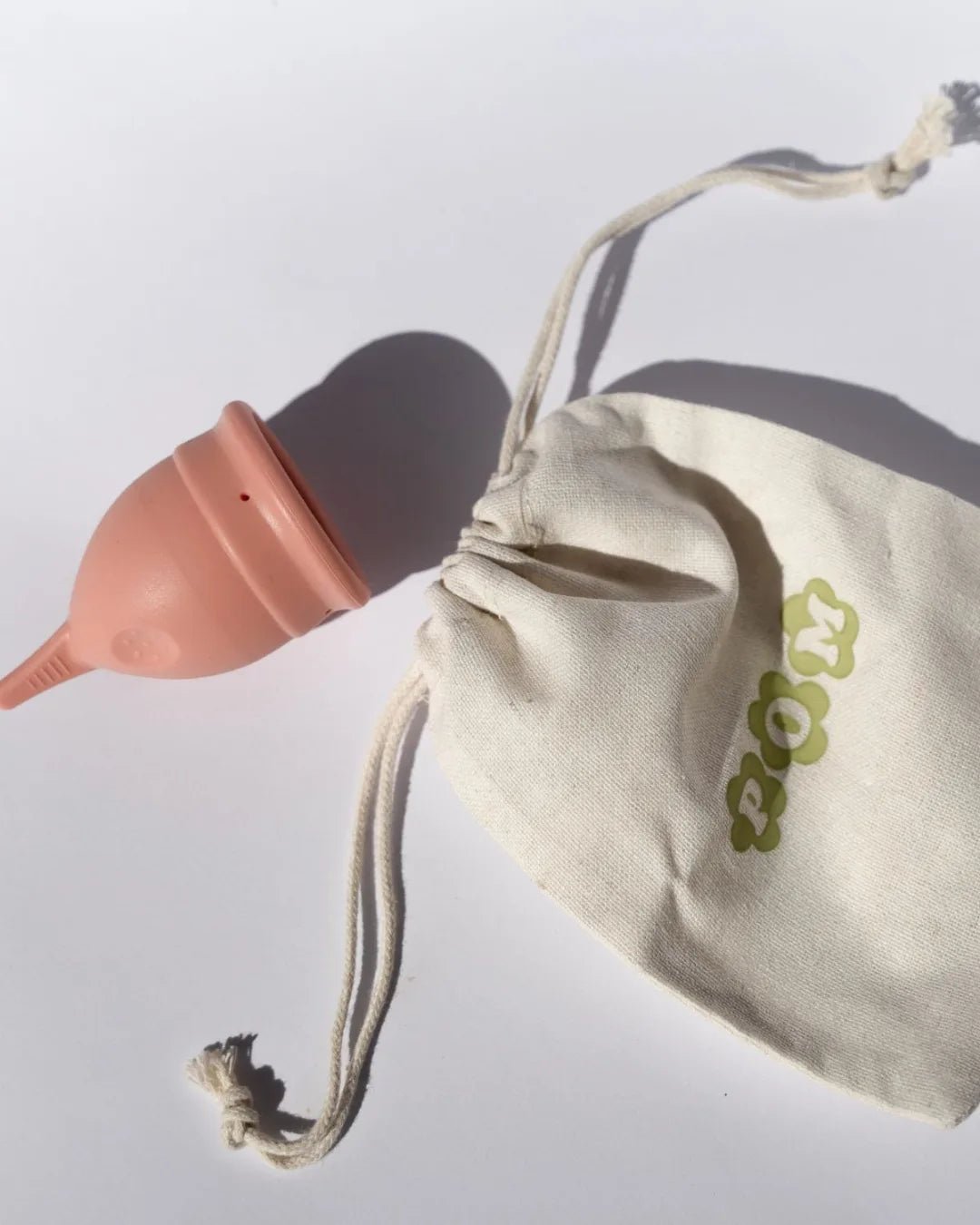 POM Finger Grip Menstrual Cup in light peach. Made from 100% medical-grade silicone, this soft, flexible cup features an easy-to-hold finger grip design for comfortable insertion and removal.