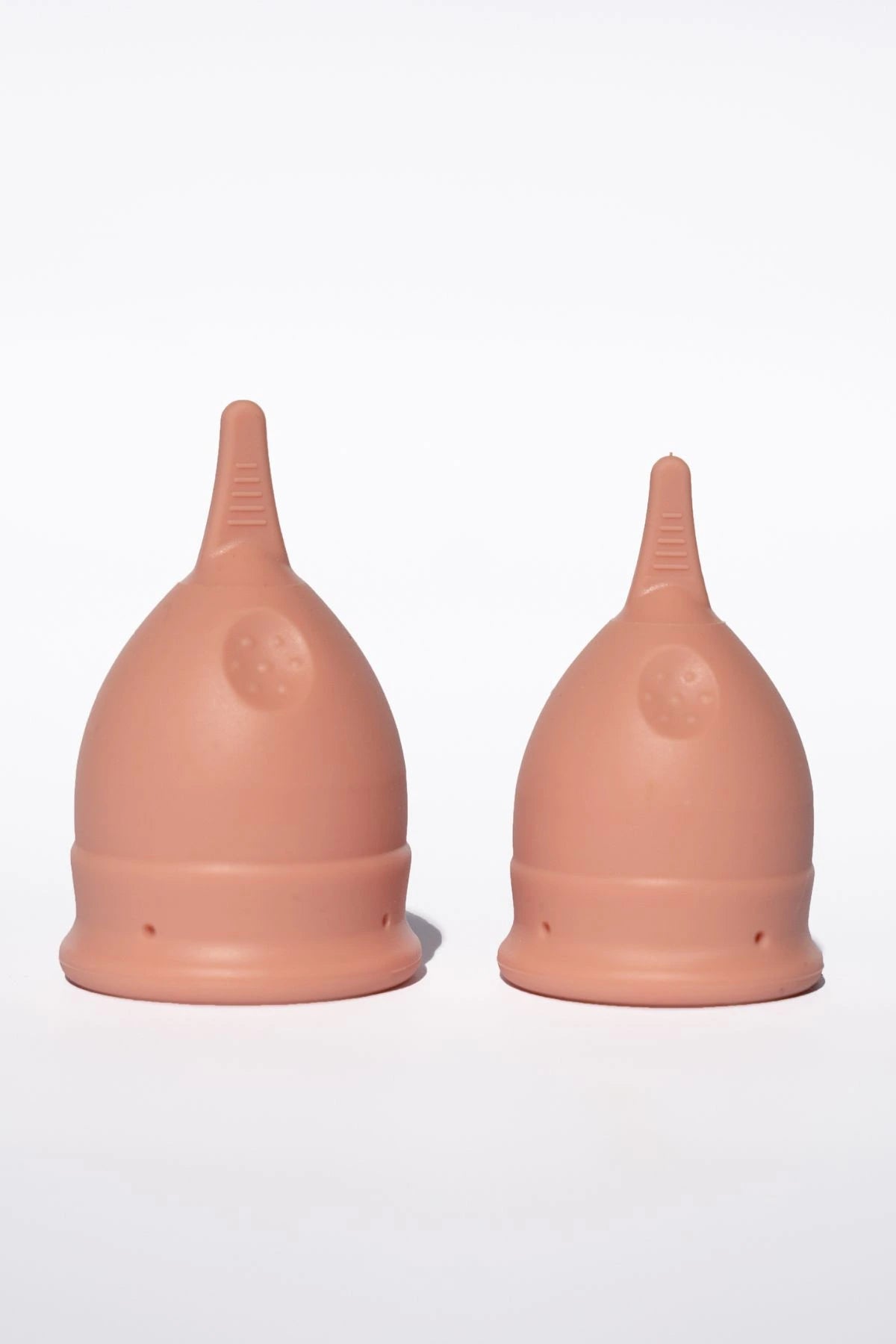 POM Finger Grip Menstrual Cups in light peach, both small and large, are made from 100% medical-grade silicone.
