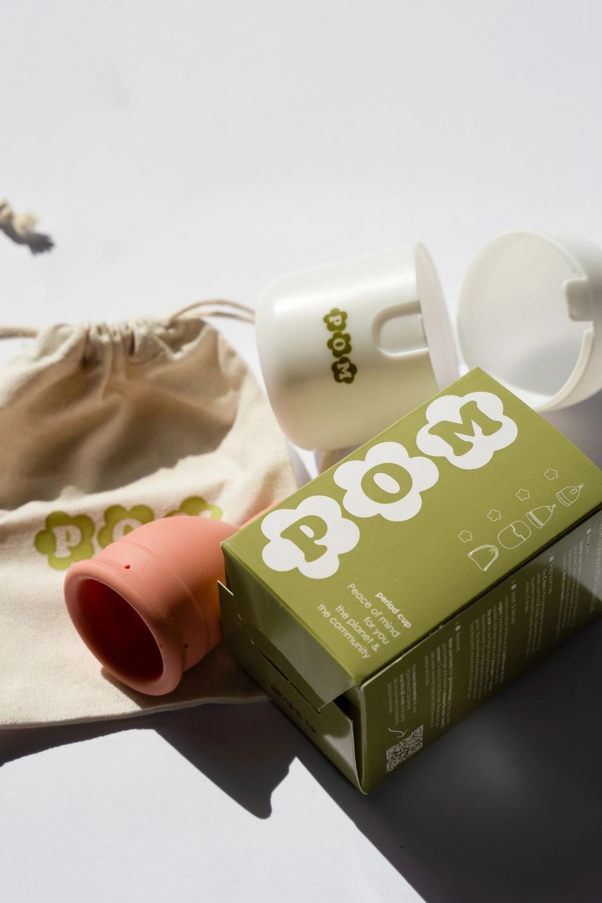 POM Finger Grip Menstrual Cup Pack, including a light peach 100% medical-grade silicone cup, branded box, organic cotton travel bag, and steriliser case.