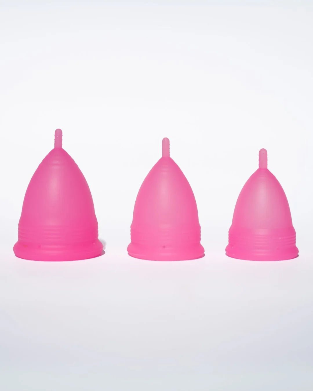 POM Super Soft Menstrual Cup in hot pink, made from 100% medical-grade silicone, featuring ribbed edges and a shorter stem for added comfort.