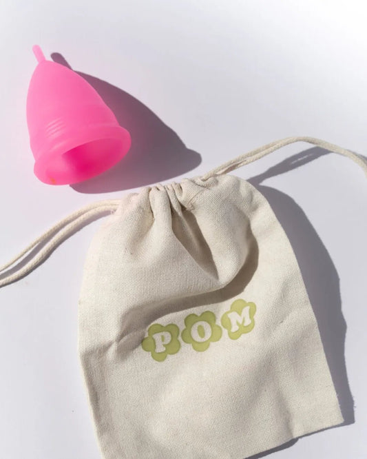 POM Super Soft Menstrual Cup in hot pink, made from 100% medical-grade silicone, featuring ribbed edges and a shorter stem for added comfort.